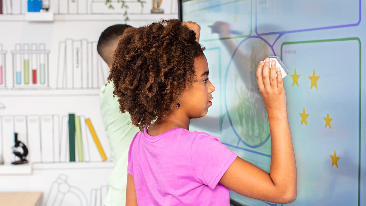 Student using a Tool Explorer stamp on a SMART Board